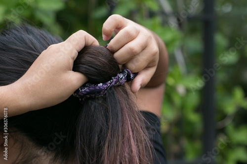close up of teen girl putting scrunchy in hair