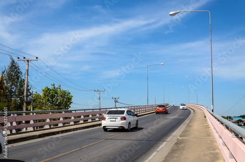 Wallpaper Mural Red car running on a bridge with blue sky background. Torontodigital.ca