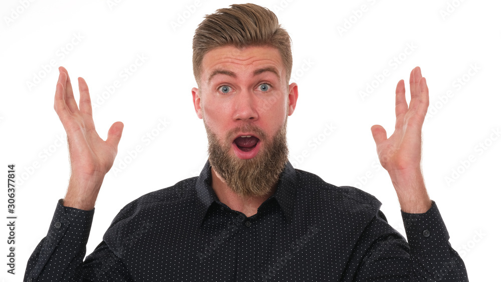 Young adult man with beard and black shirt is full of expression. Young adult man with beard and black shirt is full of expression.