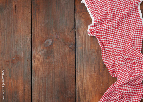 white red checkered kitchen towel on a brown wooden background