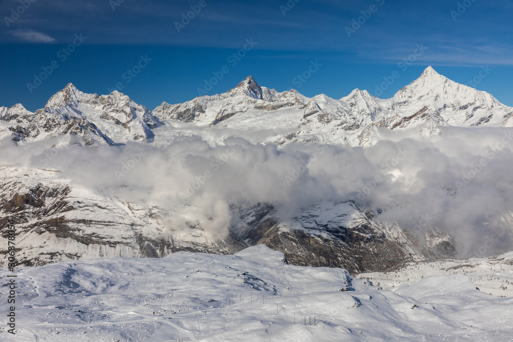 Aerial from Gornergrat surrounded by snowcapped mountains.