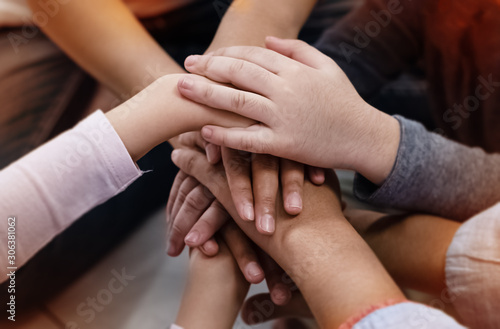 In selective focus of adult and children hands stacked together,collaborator,union,joining teamwork concepts,vintage and art tone,blurry light around