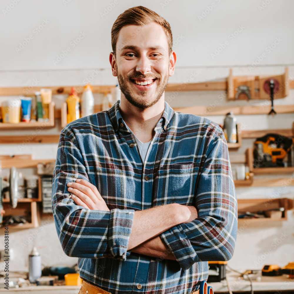 positive carpenter in apron standing with crossed arms positive carpenter in apron standing with crossed arms