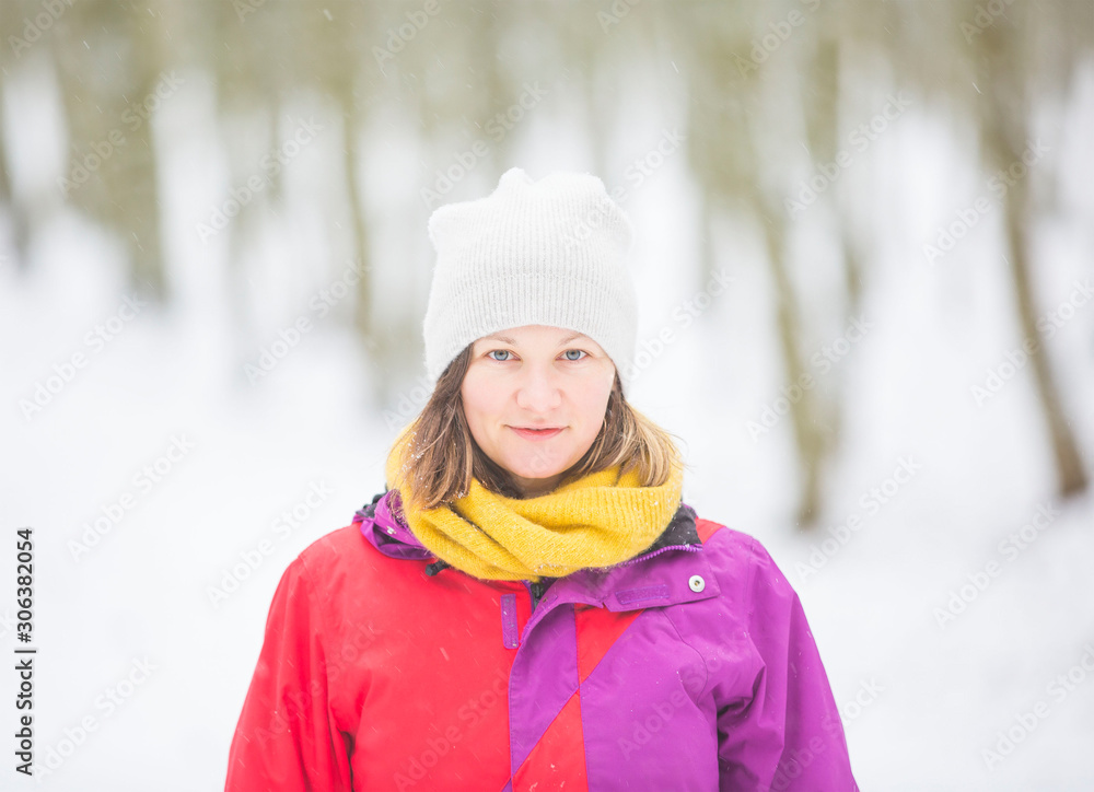 young woman portrait in the white snow
