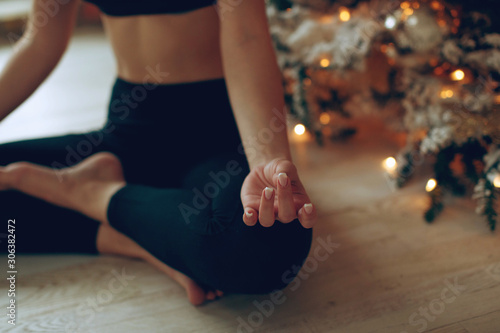Beautiful woman practices yoga in christmas. © nuzza11