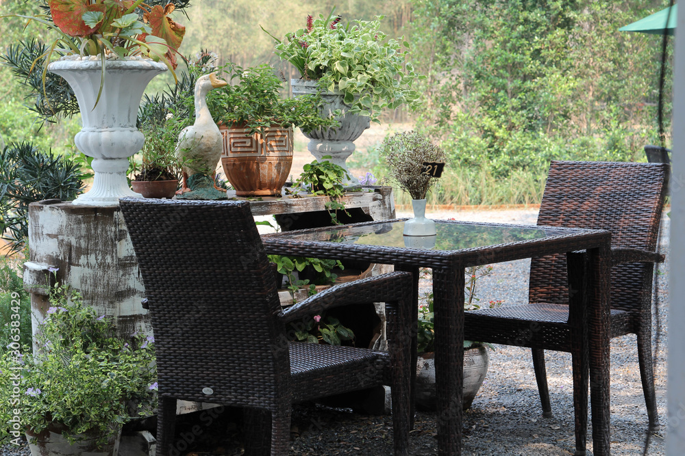 Luxury glass table and rattan chair for lunch outdoors.