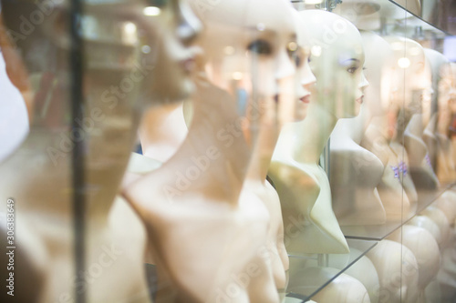 Naked female mannequins in the shop window.