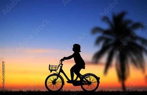 silhouette happy girl ride bike on sunrise