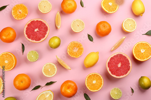 Flat lay composition with tangerines and different citrus fruits on pink background