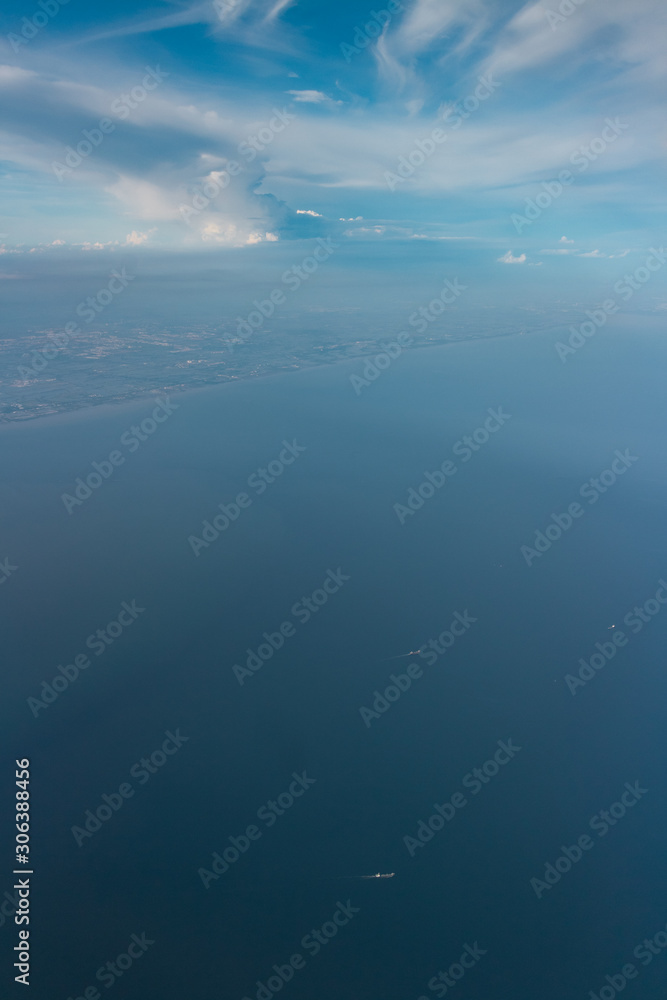 Naklejka premium clear sky with a little and ship in the sea in bird eye view