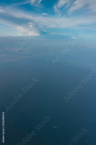 clear sky with a little and ship in the sea in bird eye view