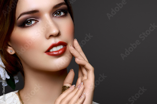 Closeup portrait beautiful girl queen look with red lipstick isolated on dark background