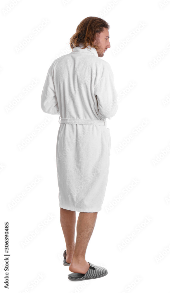 Young man in bathrobe on white background