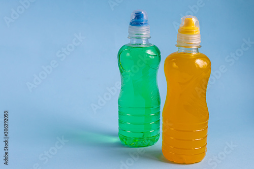 Fresh, fruit fluid for a healthy diet. Isotonic, energy drink. Two bottles with colorful water, a sports drink. Supports water balance. Copy space. 
