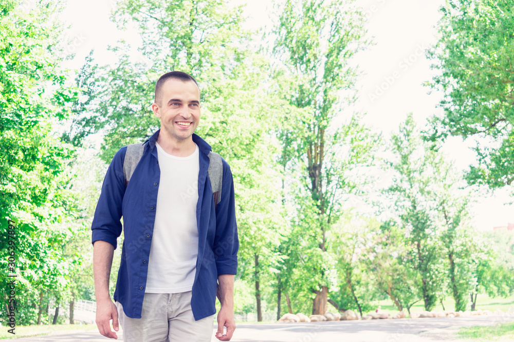 Traveler goes on the road, man with a backpack smiles, portrait, toned Traveler goes on the road, man with a backpack smiles, portrait, toned