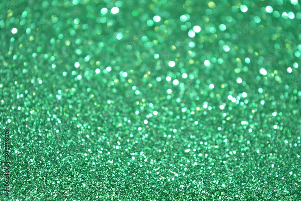 Beautiful Abstract Sparkle Glitter Lights Background. Green Emerald. Shine Bokeh Effect. For party, holidays, celebration.