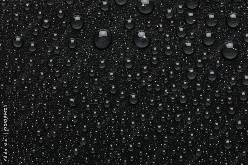 Fototapeta premium Water drops on black background, top view