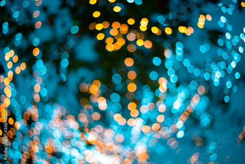 Golden bokeh mixed with blurred blue light from winter trees in Thailand. Business theoretical ideas for background use.