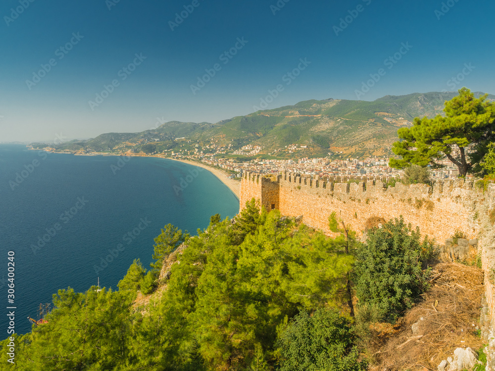 Alanya, Turkey. Beautiful view from the fortress Alanya Castle of the Mediterranean Sea and Cleopatra beach at sunset. Vacation postcard background