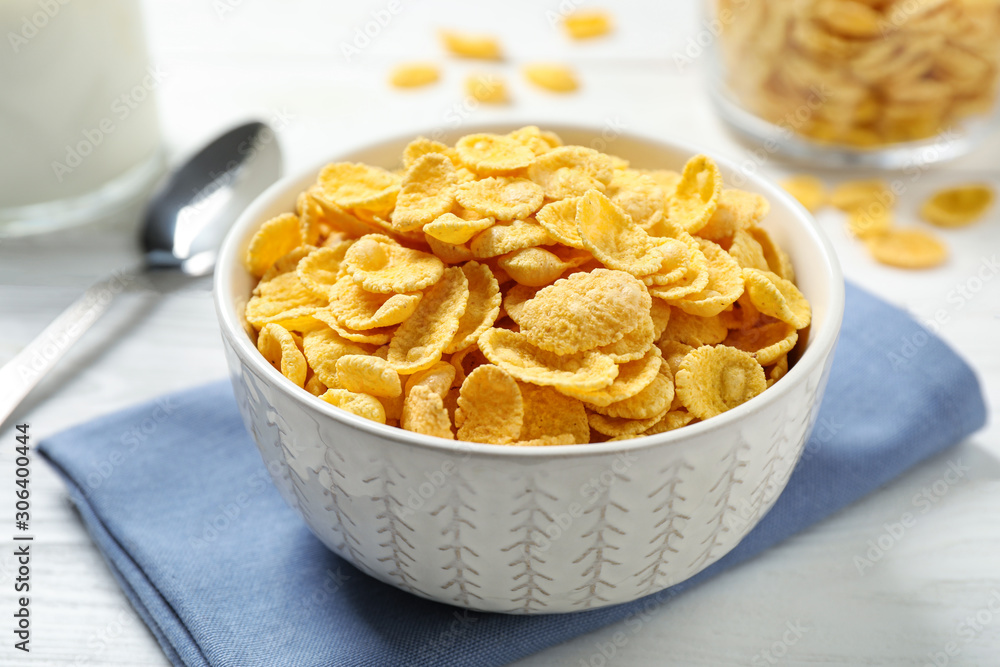 Tasty corn flakes on white wooden table Tasty corn flakes on white wooden table