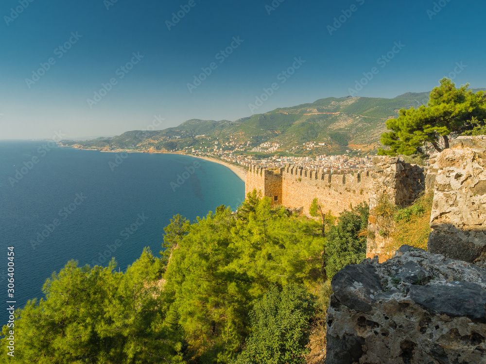 Alanya, Turkey. Beautiful view from the fortress Alanya Castle of the Mediterranean Sea and Cleopatra beach at sunset. Vacation postcard background