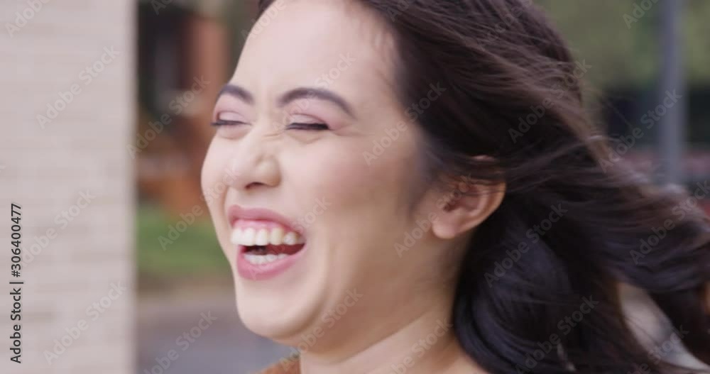 Close up - Young attractive woman breaks into laughter and a beautiful smile. - Slow Motion - shot on RED Close up - Young attractive woman breaks into laughter and a beautiful smile. - Slow Motion - shot on RED