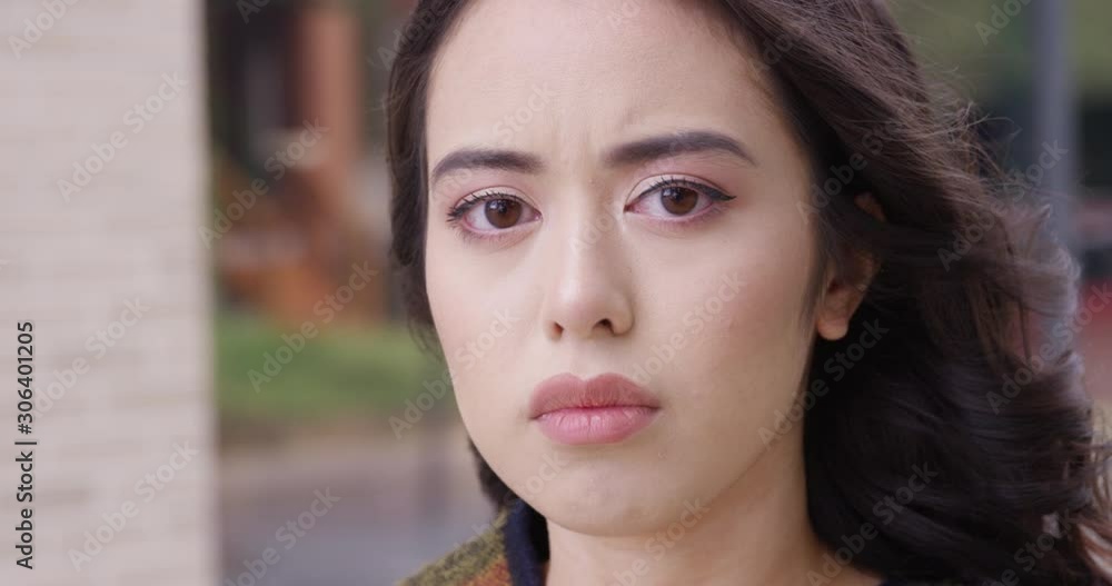 Close up - Young concerned and worried woman looks into the camera. - Slow Motion - shot on RED Close up - Young concerned and worried woman looks into the camera. - Slow Motion - shot on RED