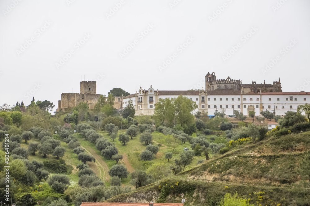 Full view at the Convent of Christ, Roman Catholic convent in Tomar, typical landscape with trees and grass, originally Templar stronghold
