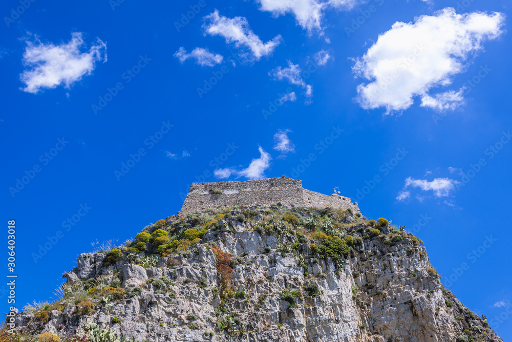 Walls of Saracen castle on a rocky hill in Taormina city, Sicily Island, Italy