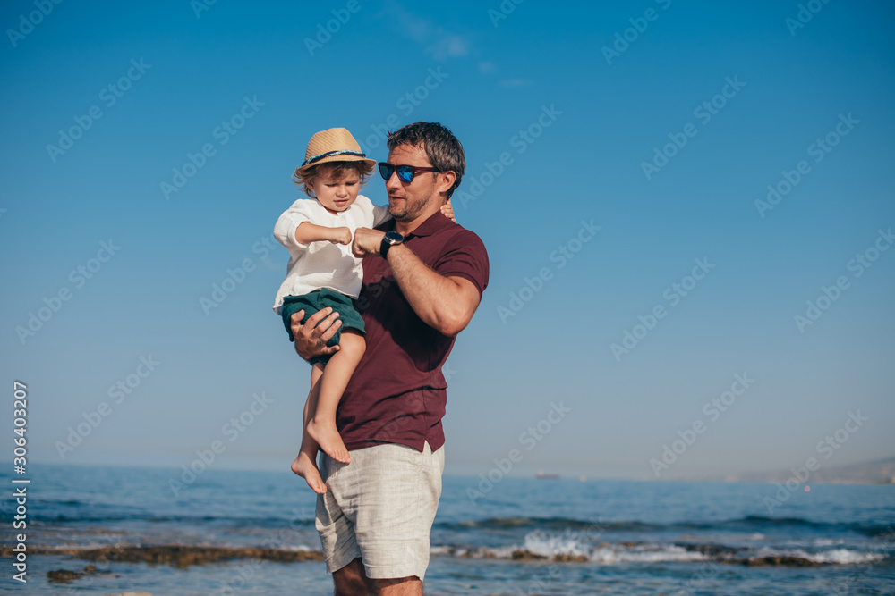 Father with a small son traveling near the sea. Father with a small son traveling near the sea.