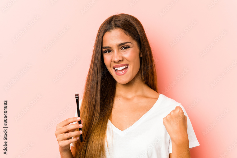Young caucasian woman holding an skinbrush cheering carefree and excited. Victory concept. Young caucasian woman holding an skinbrush cheering carefree and excited. Victory concept.