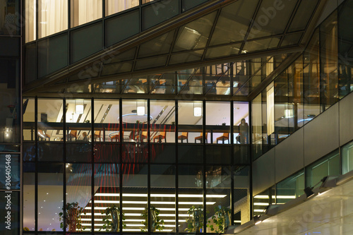Photography of Business Center in night. Interior of conference room, tables and chairs and reflections in the glass of windows. Business concepts.