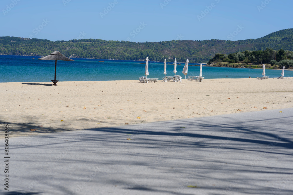 Umbrella on beautiful sand beach. Holidays, travel, vacation concept background. Umbrella on beautiful sand beach. Holidays, travel, vacation concept background.