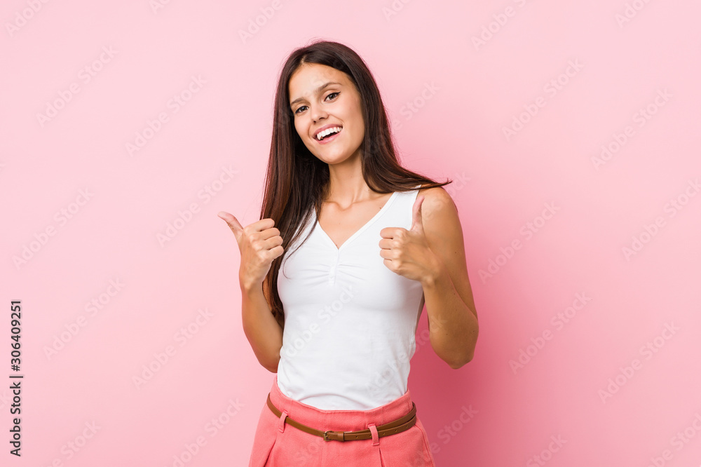 Young cute woman raising both thumbs up, smiling and confident. Young cute woman raising both thumbs up, smiling and confident.
