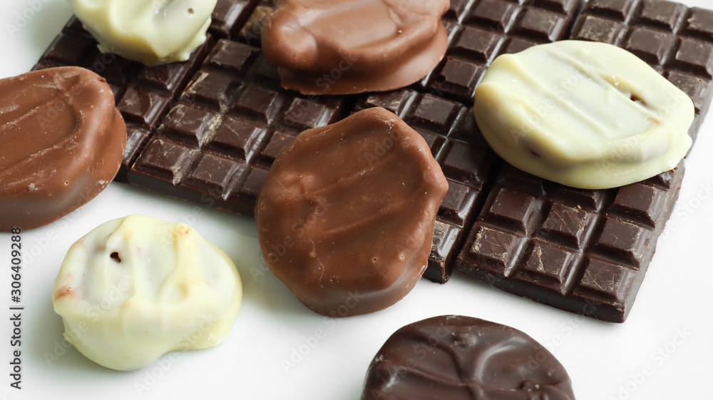 Handmade dark, white and milk chocolate on a white background. Top view Handmade dark, white and milk chocolate on a white background. Top view