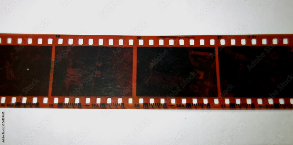 an old photographic negative stripe on white paper background.