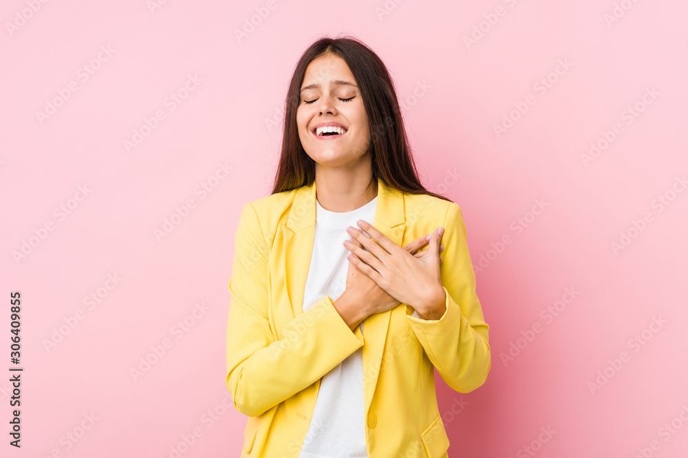 Young business woman laughing keeping hands on heart, concept of happiness. Young business woman laughing keeping hands on heart, concept of happiness.