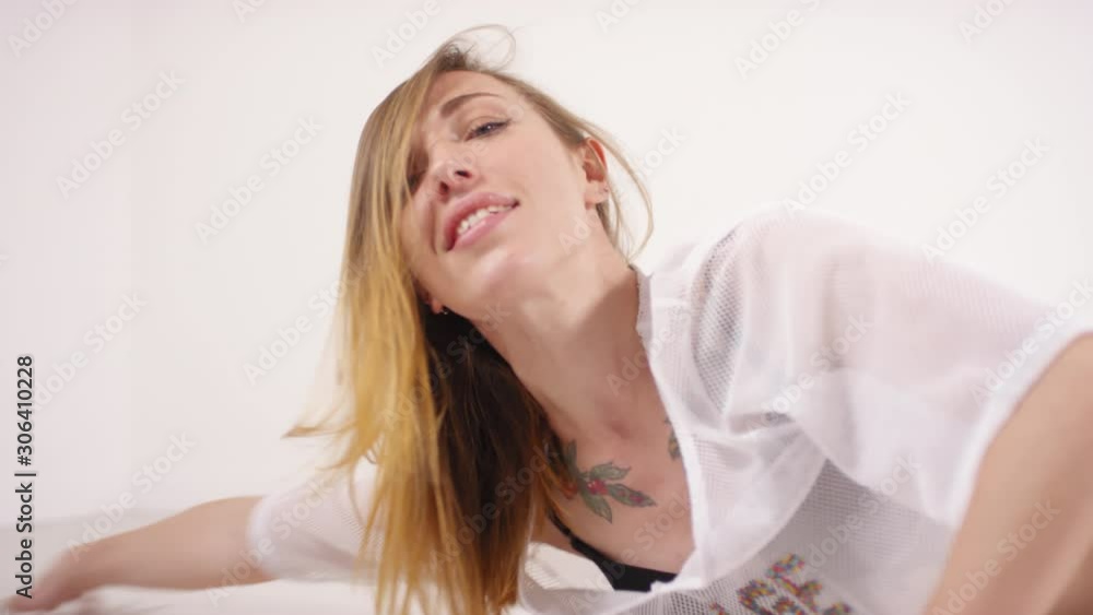 Studio shot of sensual female dancer doing body wave on the floor, looking at camera seductively and twerking in bridge pose Studio shot of sensual female dancer doing body wave on the floor, looking at camera seductively and twerking in bridge pose
