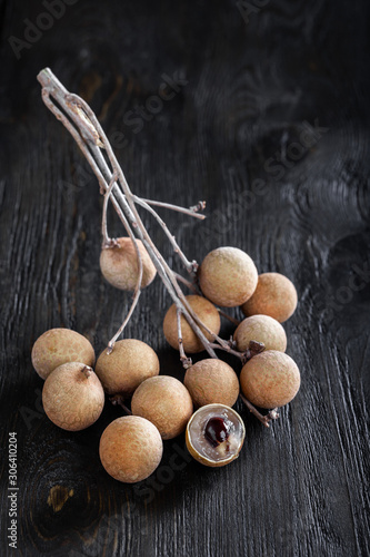 group longan fruits on a dark background, place for text