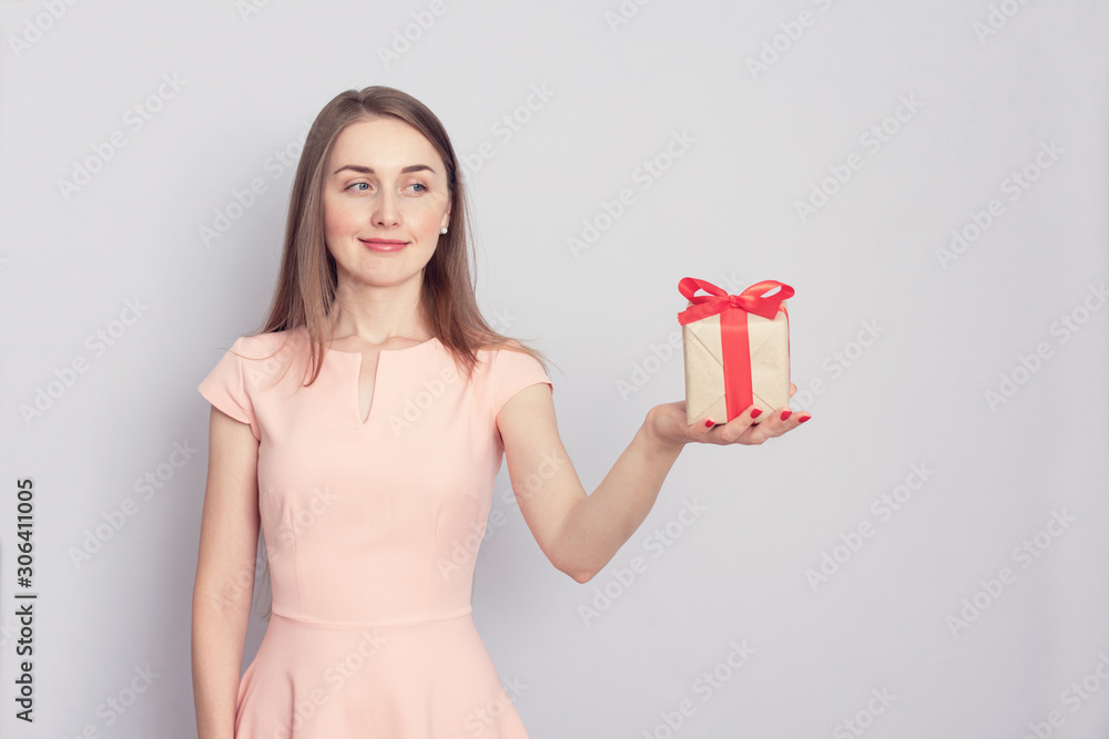 Beautiful young girl with gift, copy space, toned Beautiful young girl with gift, copy space, toned