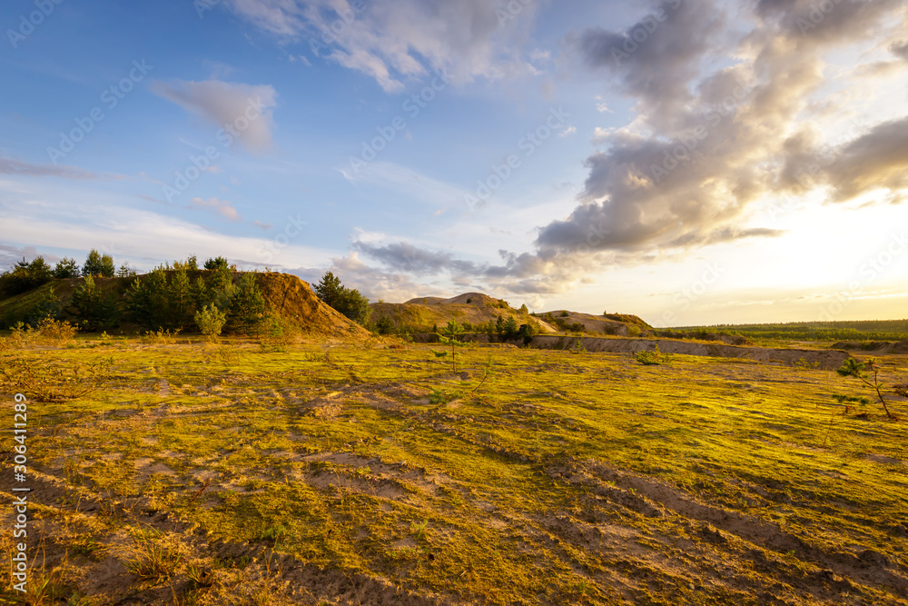 Expansive sand plain and hills covered with green moss. Summer landscape of Karelia.