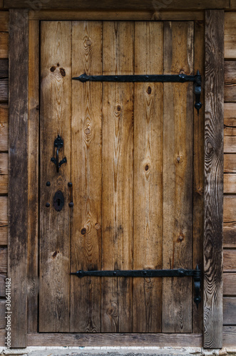 Old door from wooden boards to the bathhouse.