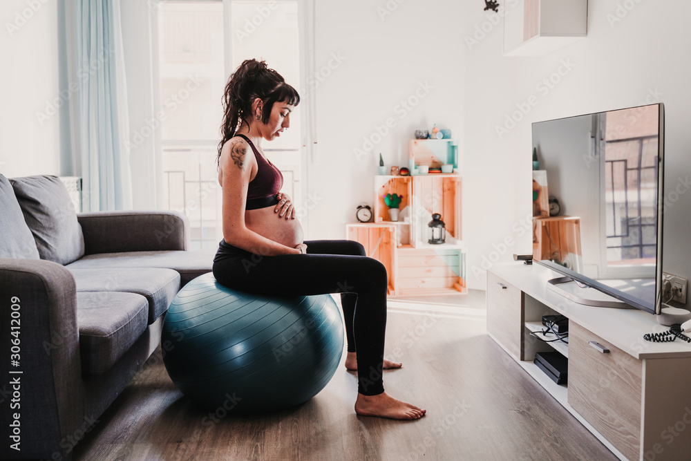 young pregnant woman at home sitting on pilates ball, healthy lifestyle young pregnant woman at home sitting on pilates ball, healthy lifestyle