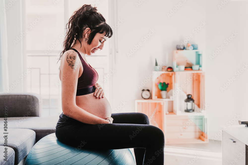 young pregnant woman at home sitting on pilates ball, healthy lifestyle young pregnant woman at home sitting on pilates ball, healthy lifestyle