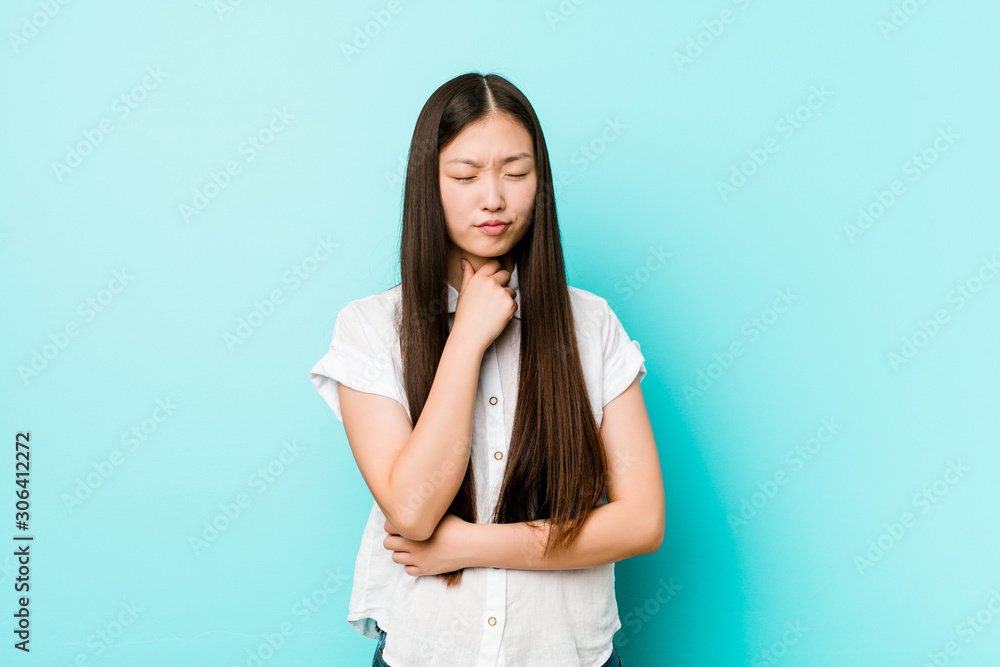 Young pretty chinese woman suffers pain in throat due a virus or infection. Young pretty chinese woman suffers pain in throat due a virus or infection.