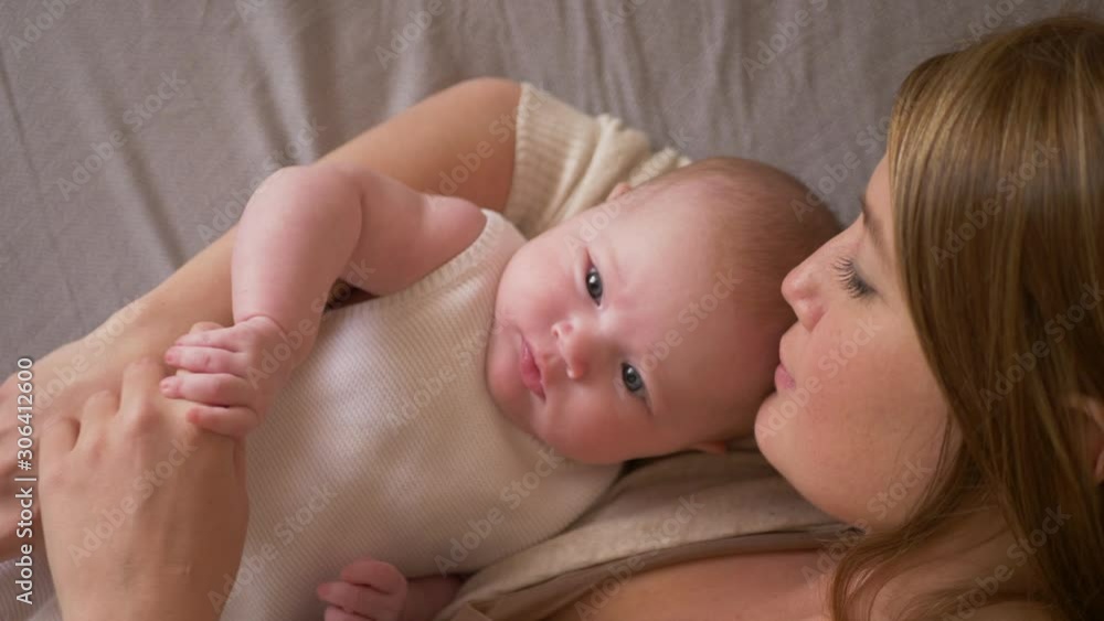 mom and little girl daughter lie on the bed mom and little girl daughter lie on the bed