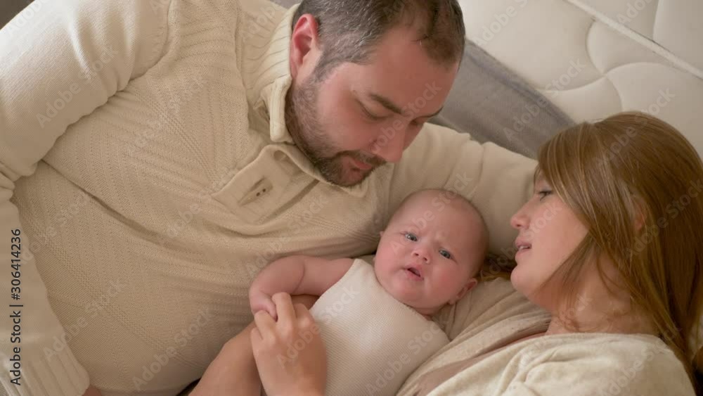 family mom dad and daughter lying on the bed family mom dad and daughter lying on the bed