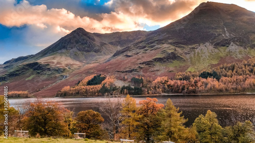 Autumn landscape of Buttermere lake in Cumbria  Lake District. Dramatic sunset in fall season colors and lake reflections in the North of England  UK. Popular destination in the mountains. 
