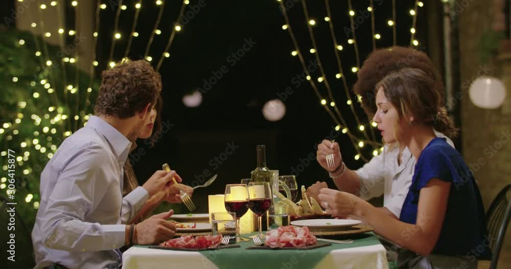 Four people, two couples happy talking and eating during a romantic gourmet dinner or lunch.Medium shot. Friends italian trip in Umbria.4k slow motion Four people, two couples happy talking and eating during a romantic gourmet dinner or lunch.Medium shot. Friends italian trip in Umbria.4k slow motion