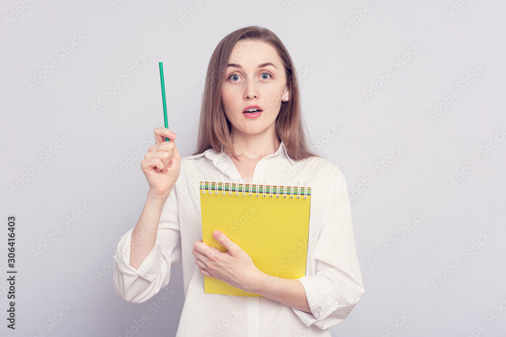 Concept of insight. Portrait beautiful girl point up find answer to question, grey background, toned Concept of insight. Portrait beautiful girl point up find answer to question, grey background, toned